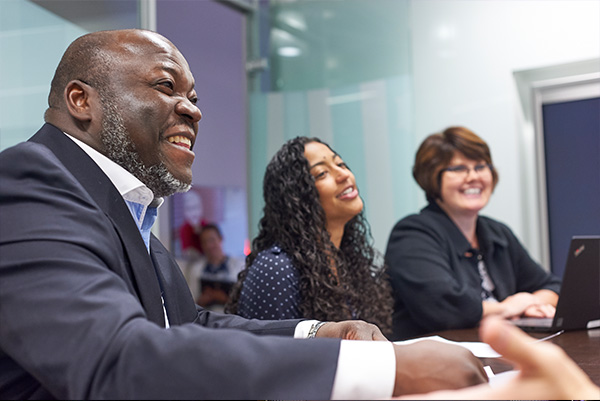 Image of 3 employees in a meeting